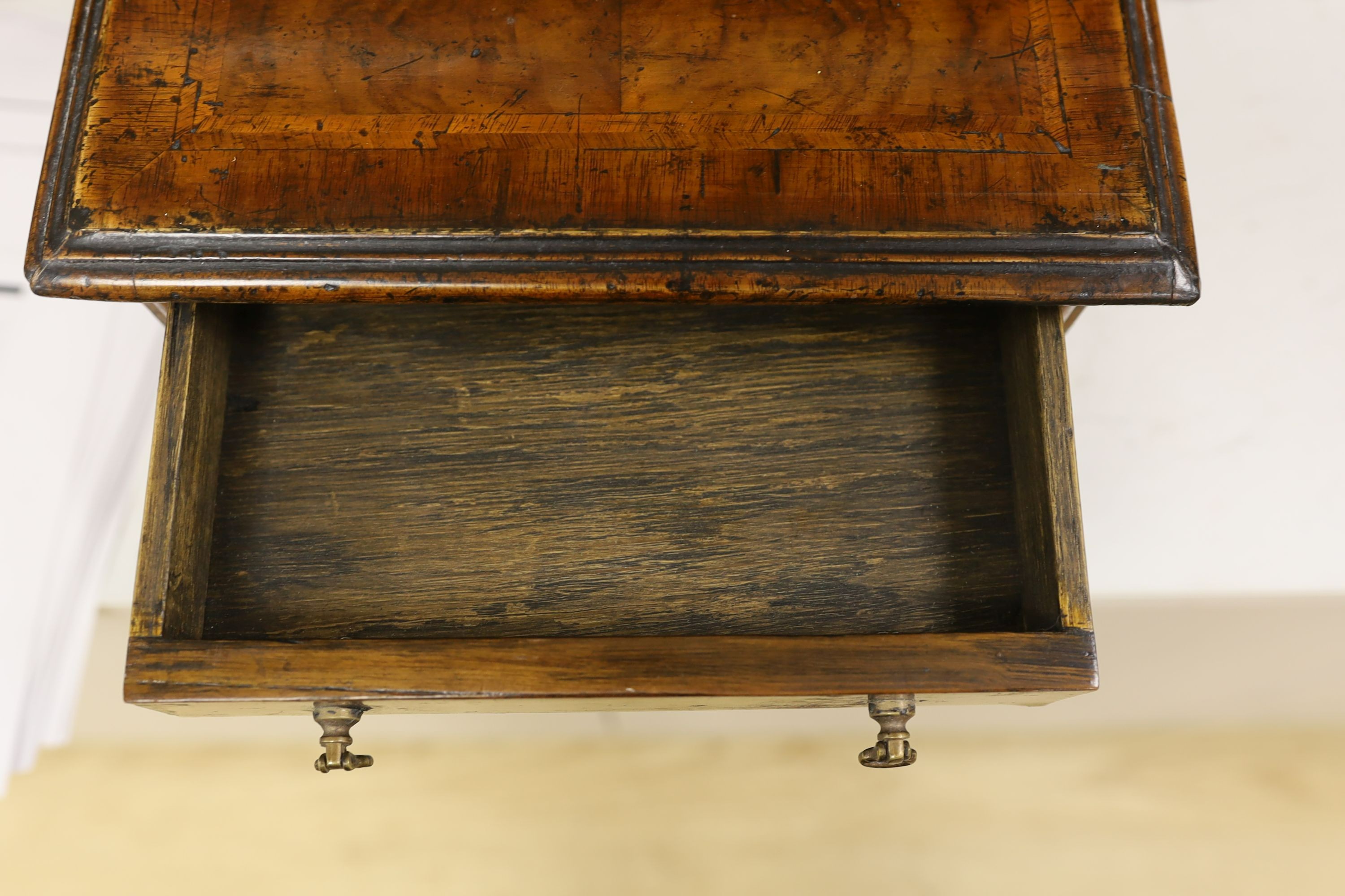 A cross banded walnut miniature chest of three drawers, 26cm wide